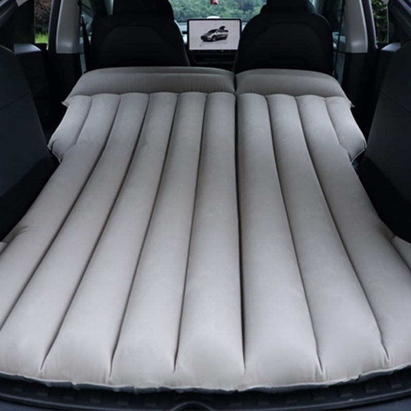 Portable car air mattress for road trips and camping, made of durable PVC material, fits in trunk as sleeping pad.