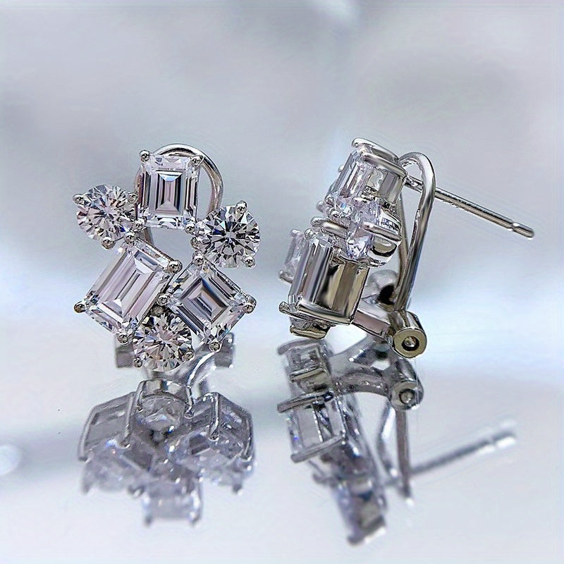 Included in the Christmas gift box are 925 sterling silver stud earrings featuring synthetic gemstones in a cluster design. These luxury and elegant earrings have no plating and are perfect for a holiday theme. The ear needle material makes them ideal