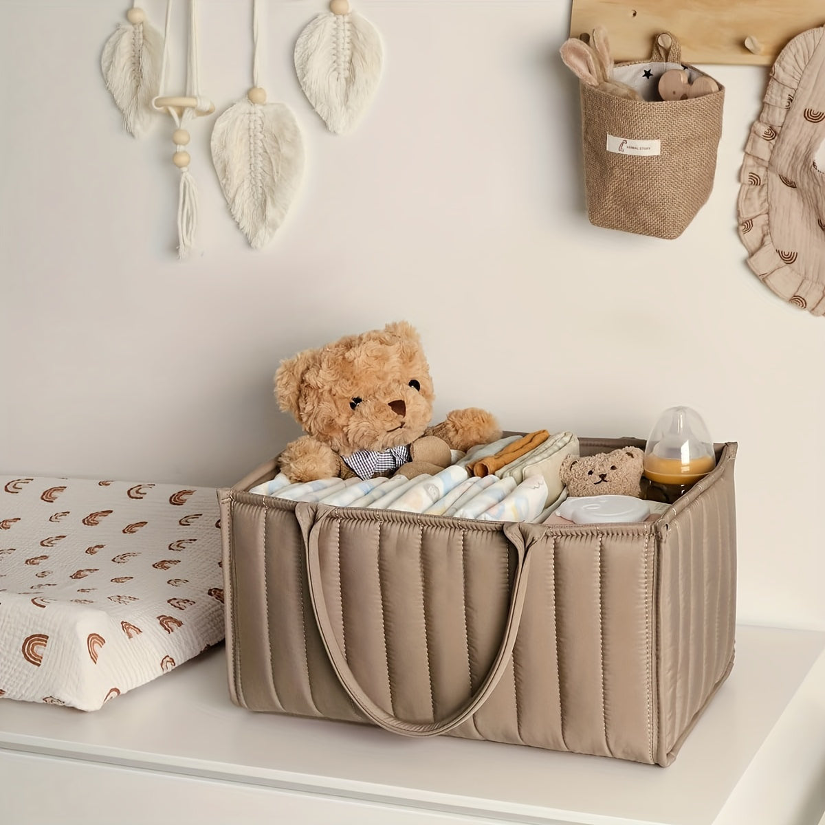 Portable nursery storage basket with handle made of polyamide, designed to organize diapers conveniently. This caddy is essential for keeping diapers, clothes, and toys in order. Perfect as a shower gift or registry item for new parents.