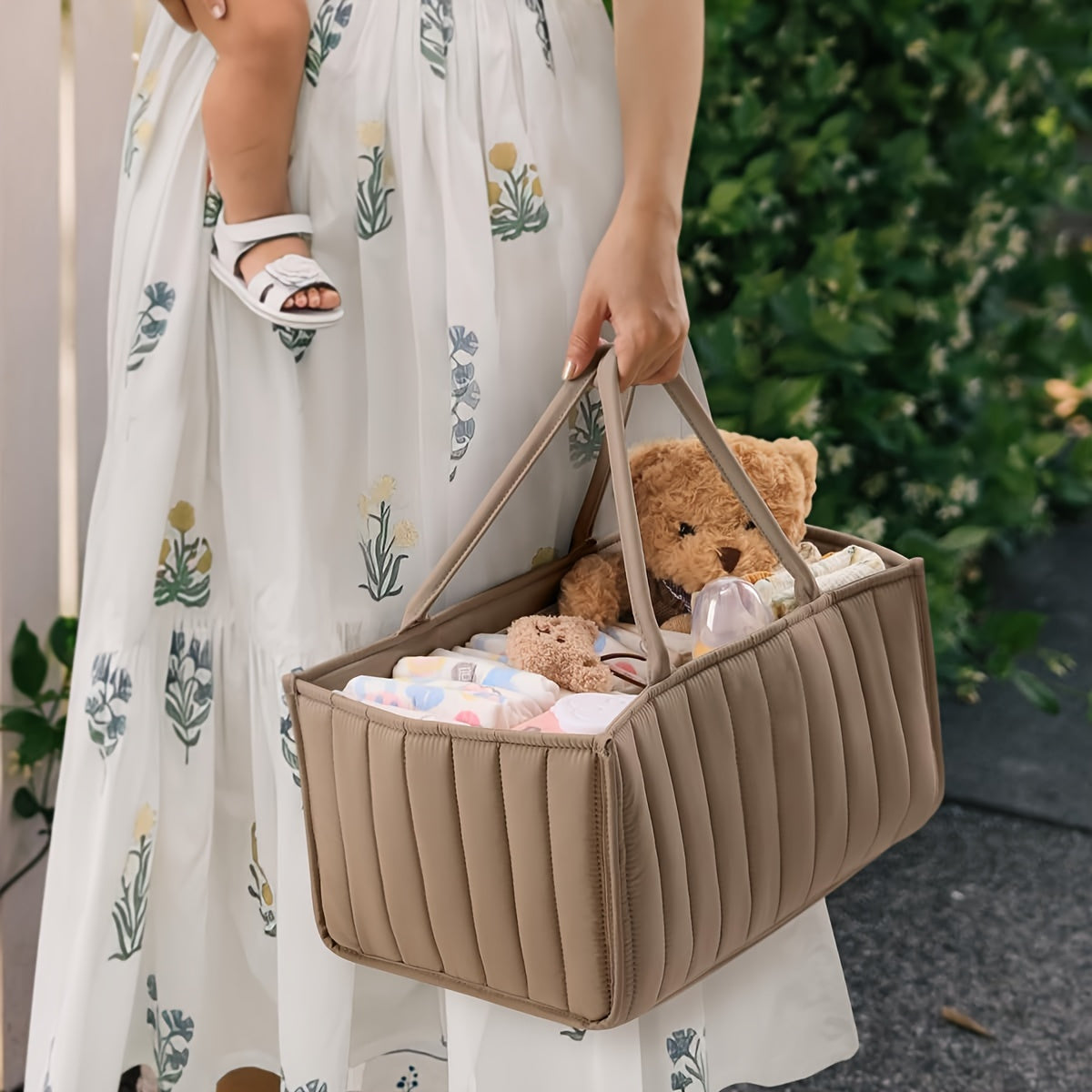 Portable nursery storage basket with handle made of polyamide, designed to organize diapers conveniently. This caddy is essential for keeping diapers, clothes, and toys in order. Perfect as a shower gift or registry item for new parents.