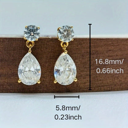 These stunning Vintage Teardrop Moissanite Drop Earrings exude elegance and charm. Crafted from 925 Sterling Silver and plated with 18K gold, each earring features a dazzling 2.5 carat moissanite stone. Perfect for both special occasions and everyday