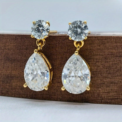 These stunning Vintage Teardrop Moissanite Drop Earrings exude elegance and charm. Crafted from 925 Sterling Silver and plated with 18K gold, each earring features a dazzling 2.5 carat moissanite stone. Perfect for both special occasions and everyday