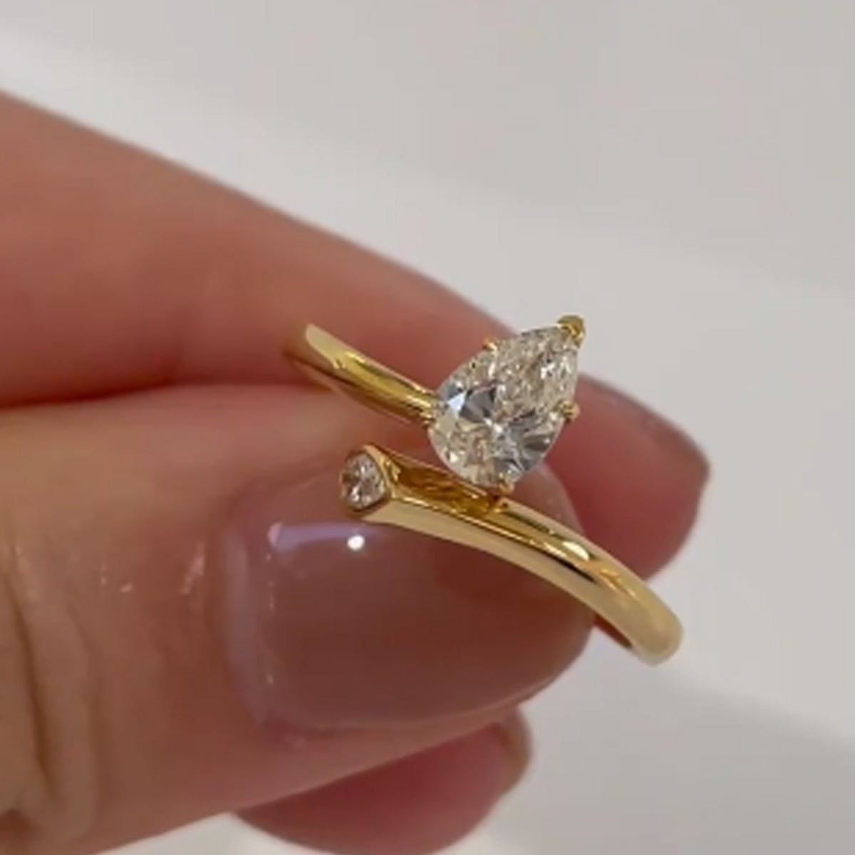 Luxurious 18K Gold Plated 925 Silver Moissanite Engagement Ring featuring a stunning 2 Carat Pear Shaped Gemstone. This Boho Royal Style ring is perfect for an April Birthstone or as a Solitaire Ring for a Wedding or Valentine's Day gift. Comes in a