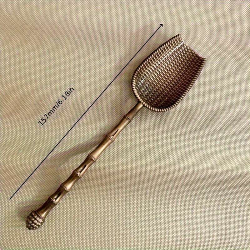 Elegant vintage metal tea scoop for loose leaf teas, coffee, and spices with long handle. Perfect for home kitchen use.