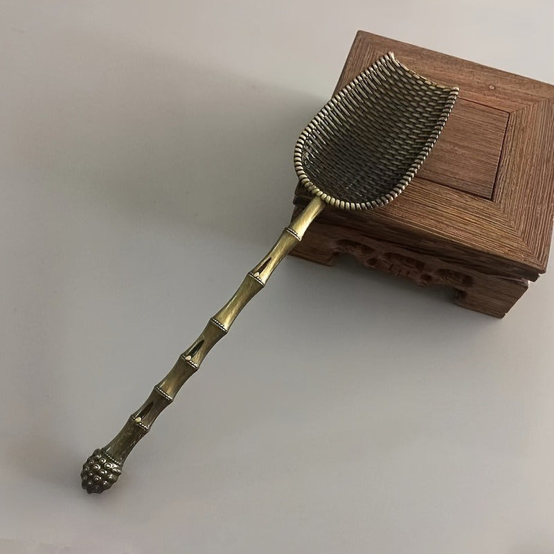 Elegant vintage metal tea scoop for loose leaf teas, coffee, and spices with long handle. Perfect for home kitchen use.