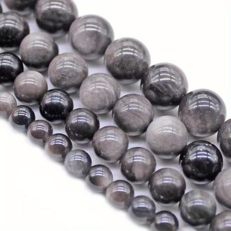 XULIN offers a set of 6/8/10mm Natural Stone 7A Silvery Obsidian Beads, perfect for DIY jewelry making. These lustrous round faux gemstones can be used to create beautiful necklaces, bracelets, and earrings. Ideal for crafting fashionable and romantic