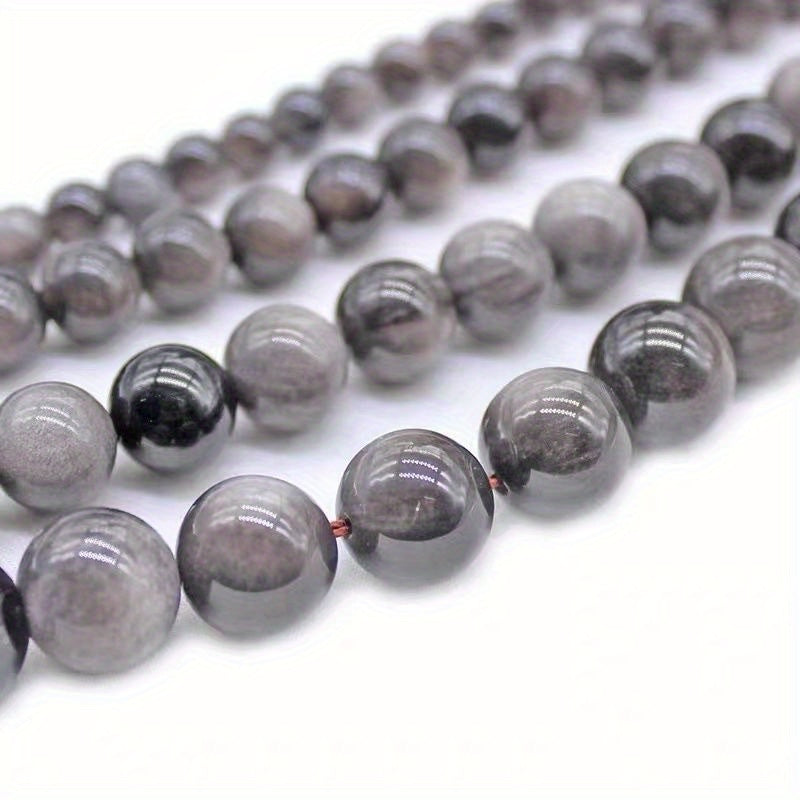 XULIN offers a set of 6/8/10mm Natural Stone 7A Silvery Obsidian Beads, perfect for DIY jewelry making. These lustrous round faux gemstones can be used to create beautiful necklaces, bracelets, and earrings. Ideal for crafting fashionable and romantic