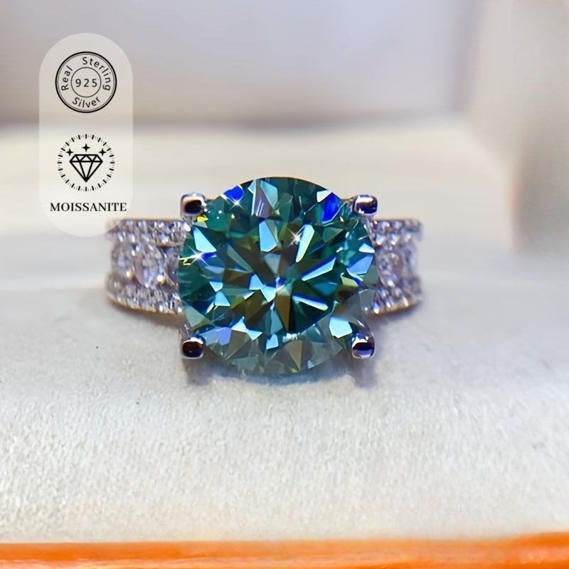 The 925 sterling silver promise ring features an elegant 10ct blue-green Moissanite stone in a 4-prong setting. It is hypoallergenic and coated with 18K golden plating, making it an ideal choice for daily wear or as a gift for Valentine's Day. This ring