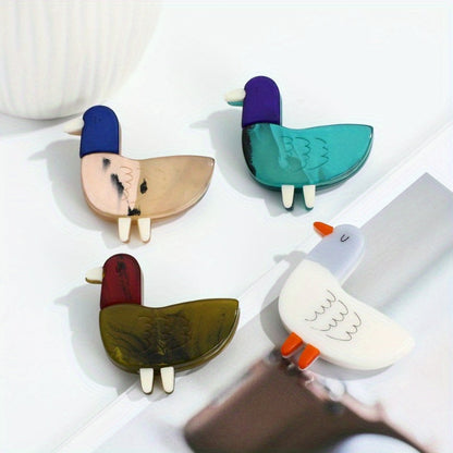 Animal-shaped acrylic duckling brooch pin with color block design is a cute fashion accessory for collars and clothing.