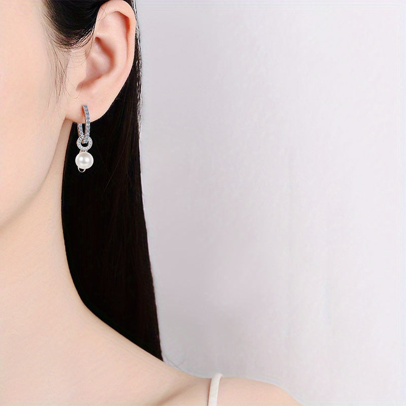 Elegant Shavano Drop Earrings featuring a 1.1 Carat Moissanite & Freshwater Pearl, crafted in 925 Sterling Silver. These earrings are perfect for weddings and gift-giving. They are inlaid with a secure clasp and weigh 4.7g.