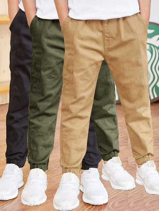 Boys' casual cargo pants in solid color cotton, perfect for outdoor activities.