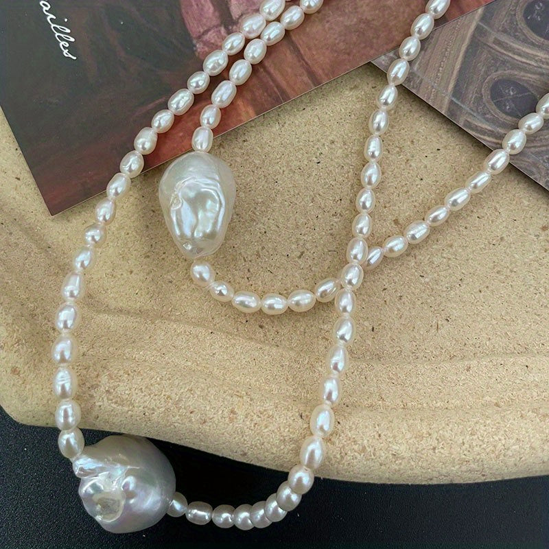 This handcrafted luxury necklace features elegant Baroque style natural freshwater pearls on an irregular clavicle chain. Each pearl has a unique storytelling quality with natural imperfections, making it perfect for daily wear or on vacation. Elevate