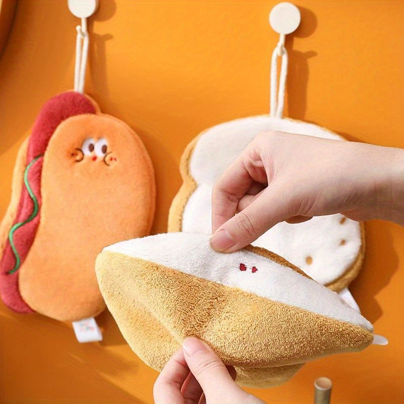 Cartoon food shaped hand towel made of soft coral fleece, quick-dry and absorbent for bathroom or kitchen use. Features designs of cheese, bread, and cookies, can be used as hanging wipe cloth. No electricity required.