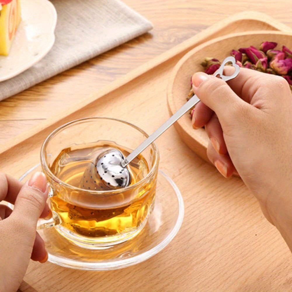 Heart-shaped tea infuser set made from stainless steel, available in a 1pc or 2pcs option. Features a fine mesh for loose leaf tea, sturdy handle for easy use, and is perfect for brewing tea, herbs, and spices. Durable, easy to clean, and makes for an