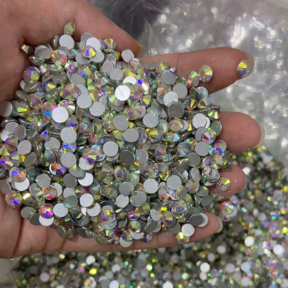 10,000 pieces of Crystal AB Flatback Rhinestones available for Nail Art, DIY Crafts, and Jewelry Making. These Non-Hotfix Resin Gems are perfect for adding a touch of sparkle to your projects.