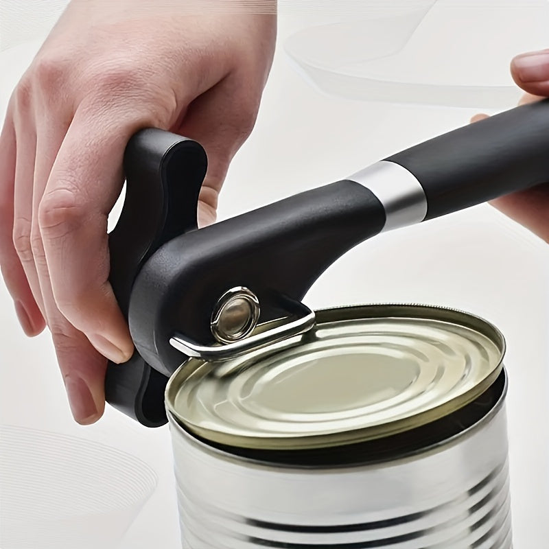 A manual can opener made of stainless steel, featuring a safety smooth edge, non-slip handle, and easy turn adjustable knob for effortless food preparation in the kitchen.