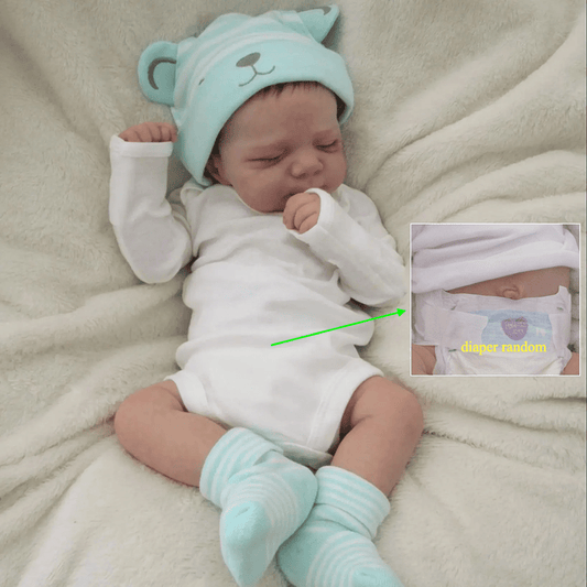 Realistic 18-inch reborn girl doll with blue bear hat, soft vinyl body, detailed skin, visible veins, and lifelike sleeping pose. Ideal birthday gift for children 3 and up.