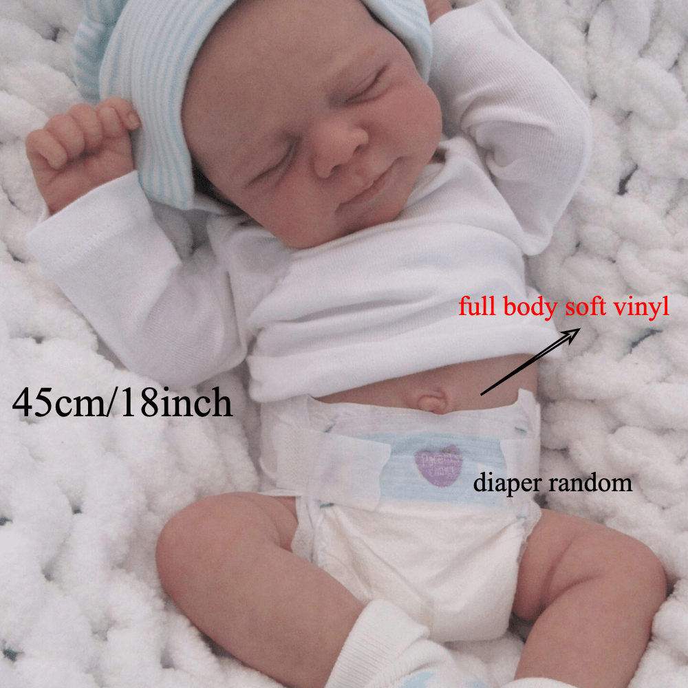 Realistic 18-inch reborn girl doll with blue bear hat, soft vinyl body, detailed skin, visible veins, and lifelike sleeping pose. Ideal birthday gift for children 3 and up.