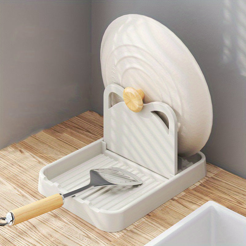 Multi-functional kitchen organizer that can hold pot lids and spoons, can be folded and mounted on the wall or placed on the countertop, made of durable plastic.