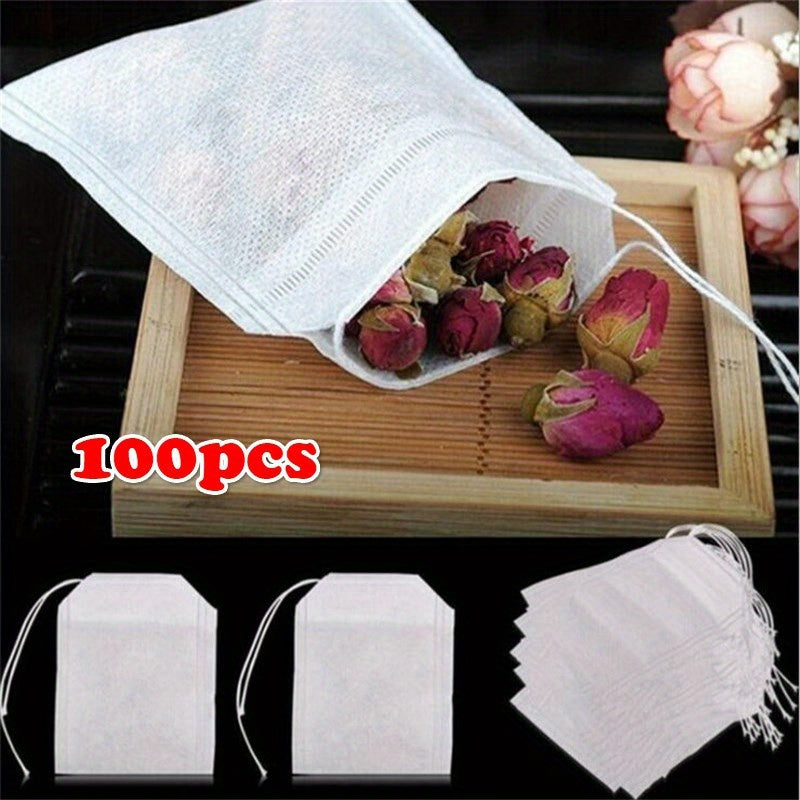 100 premium drawstring tea bags made of white non-woven fabric measuring 5.51X7.01cm, perfect for loose leaf tea, herbs, and spices.