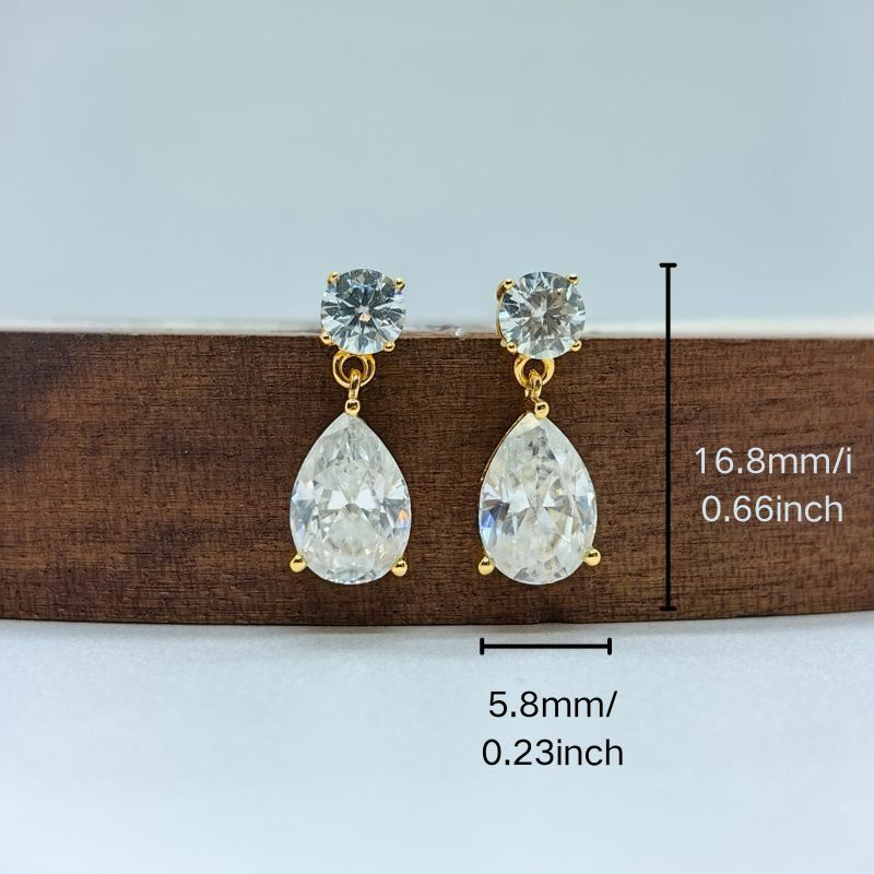 Set of 2 luxurious 18K gold-plated 925 sterling silver stud earrings featuring 2.5 carat pear-cut Moissanite stones. These classic style earrings are perfect for weddings, banquets, or Halloween parties. Each earring is adorned with synthetic November