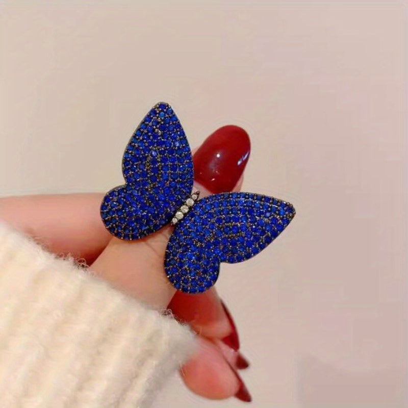 Add a touch of elegance to your outfit with this set of two stunning royal blue butterfly brooches adorned with sparkling rhinestones. This versatile and luxurious accessory is perfect for women to style in both winter and autumn seasons.