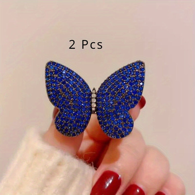 Add a touch of elegance to your outfit with this set of two stunning royal blue butterfly brooches adorned with sparkling rhinestones. This versatile and luxurious accessory is perfect for women to style in both winter and autumn seasons.