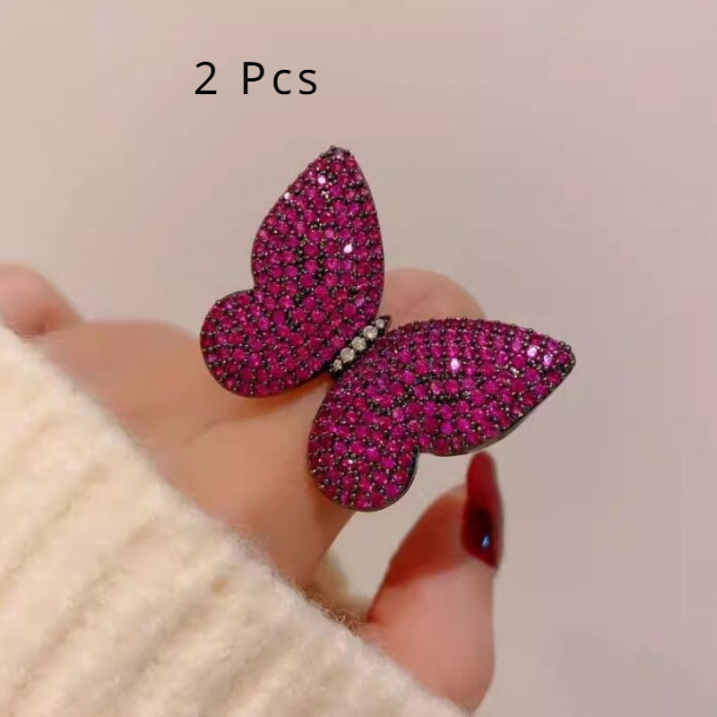 Add a touch of elegance to your outfit with this set of two stunning royal blue butterfly brooches adorned with sparkling rhinestones. This versatile and luxurious accessory is perfect for women to style in both winter and autumn seasons.