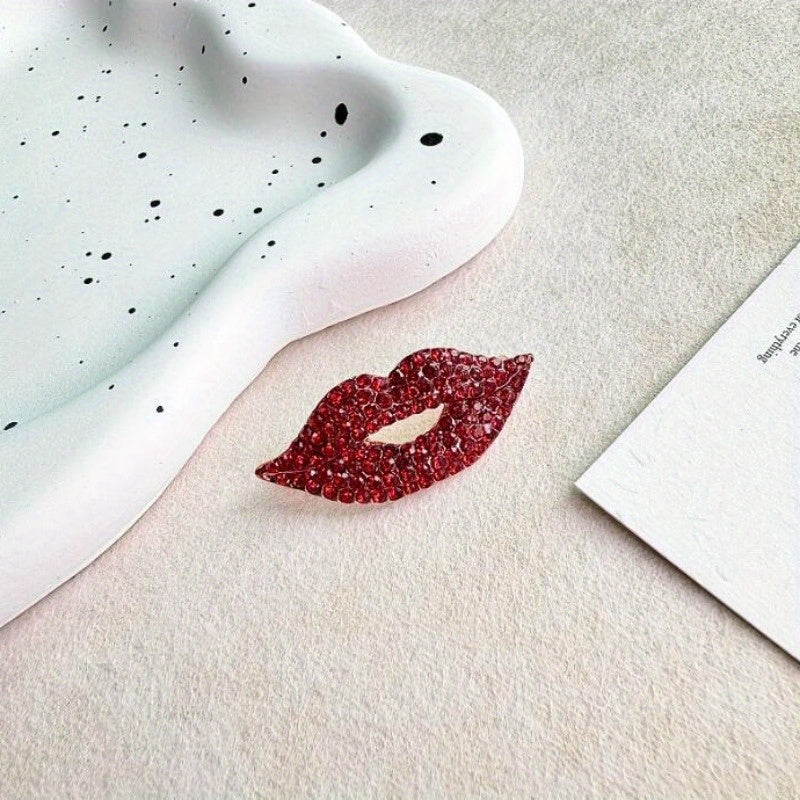 Two pieces of a sexy red lip brooch adorned with sparkling diamonds, creating a fashionable and luxurious accessory for high-end clothing.