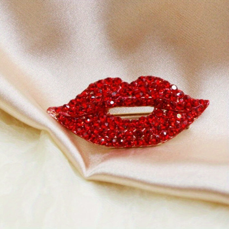 Two pieces of a sexy red lip brooch adorned with sparkling diamonds, creating a fashionable and luxurious accessory for high-end clothing.