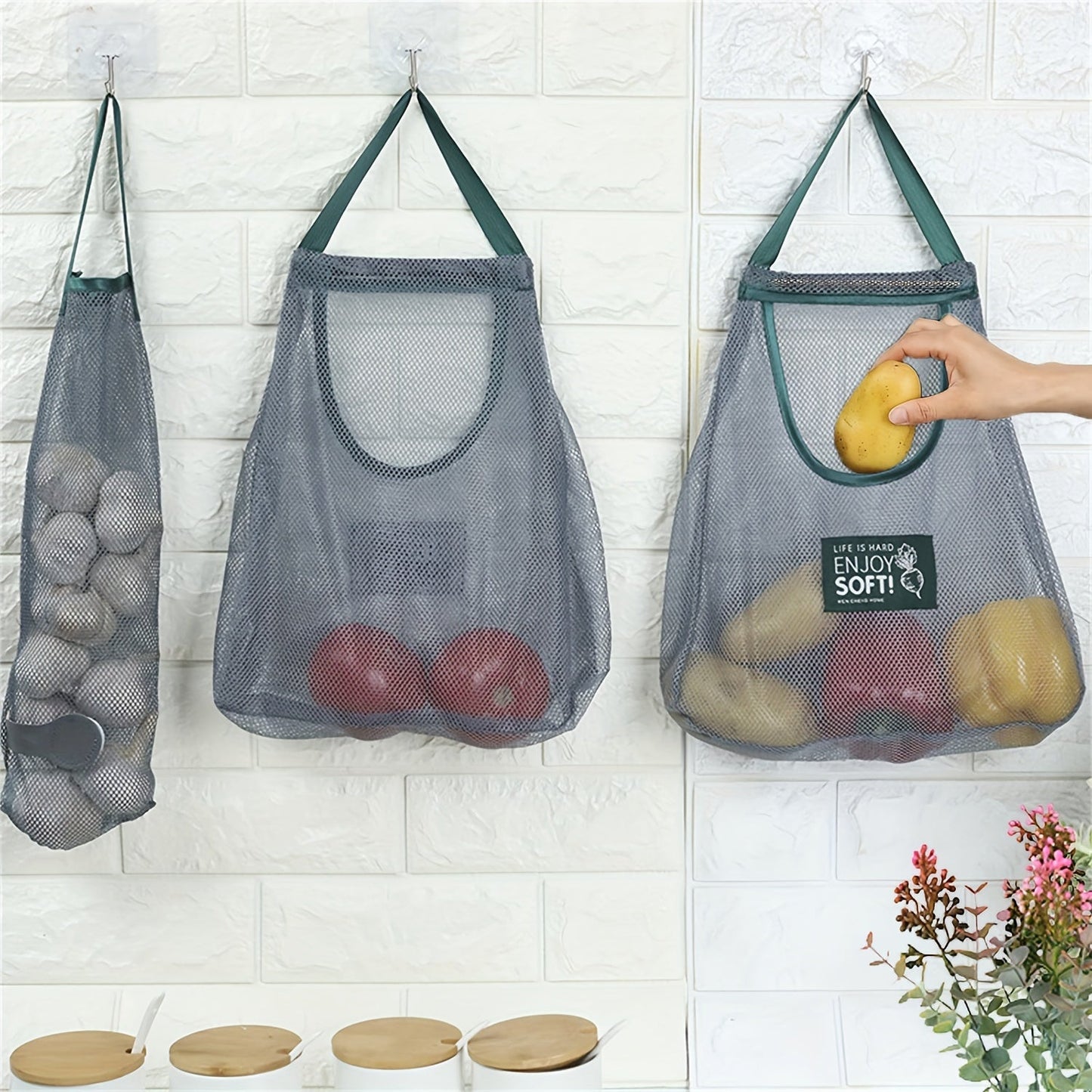 This heavy-duty hanging mesh storage bag with drawstring closure is ideal for organizing garlic, potatoes, and onions. Made of durable plastic with a breathable design, it is perfect for kitchen organization. The hanging produce bags feature visible