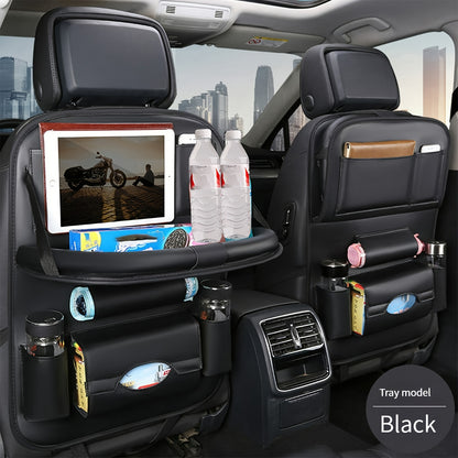 Car backseat organizer with foldable table tray made of premium PU leather for storing snacks, beverages, and entertainment items.