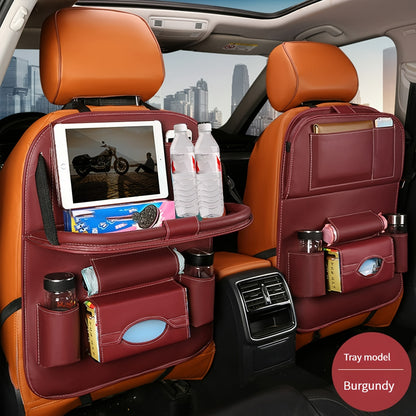 Car backseat organizer with foldable table tray made of premium PU leather for storing snacks, beverages, and entertainment items.