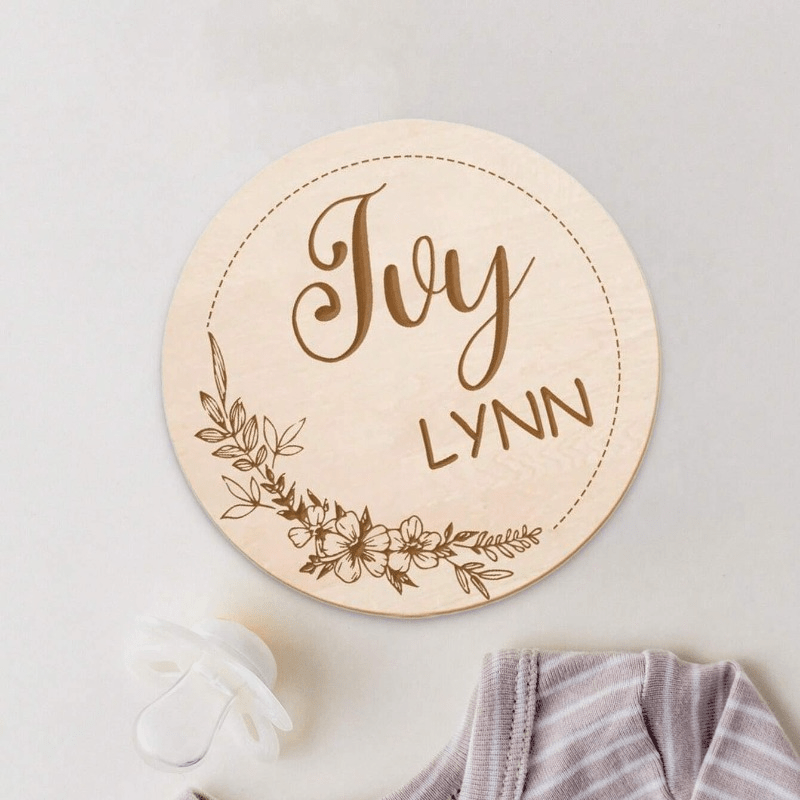 Customize your nursery decor with a personalized wooden name sign! This round plaque can be customized with a footprint and makes for a unique shower gift or photo prop.