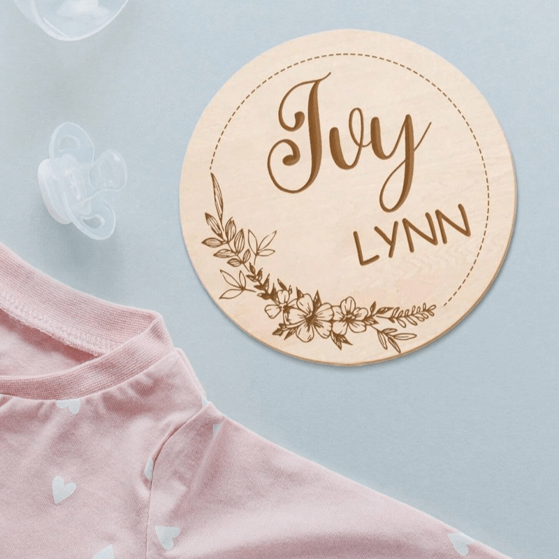 Customize your nursery decor with a personalized wooden name sign! This round plaque can be customized with a footprint and makes for a unique shower gift or photo prop.