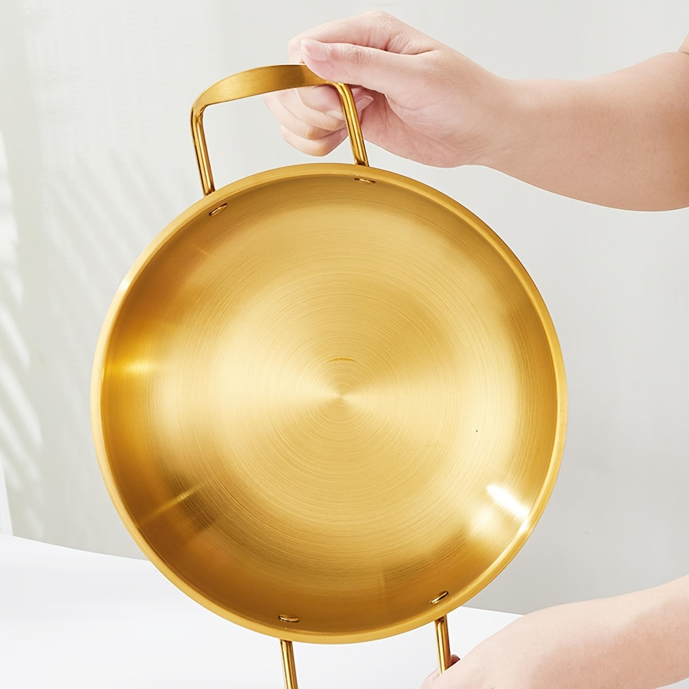 Kitchen cooking noodle pot made of 1 piece stainless steel with a golden thread design.