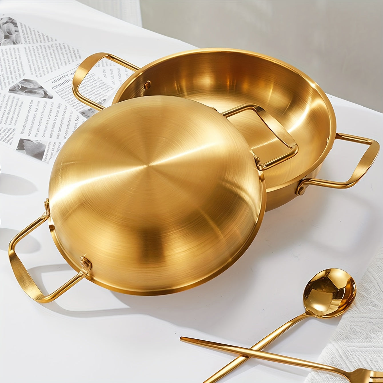 Kitchen cooking noodle pot made of 1 piece stainless steel with a golden thread design.