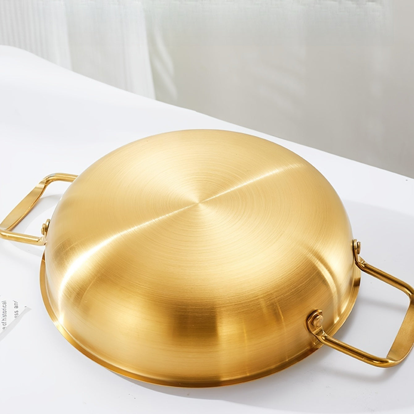 Kitchen cooking noodle pot made of 1 piece stainless steel with a golden thread design.