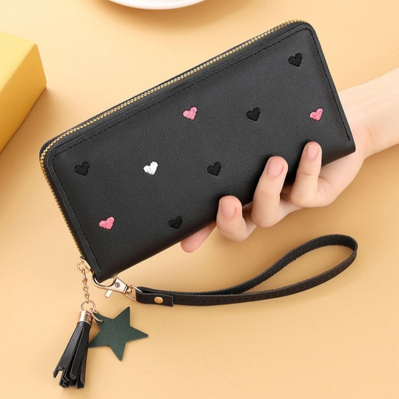 Heart and star embroidered tassel wallet with Korean style, zip-around coin purse. Ideal gift for special occasions. Embroidered clutch in faux leather material.