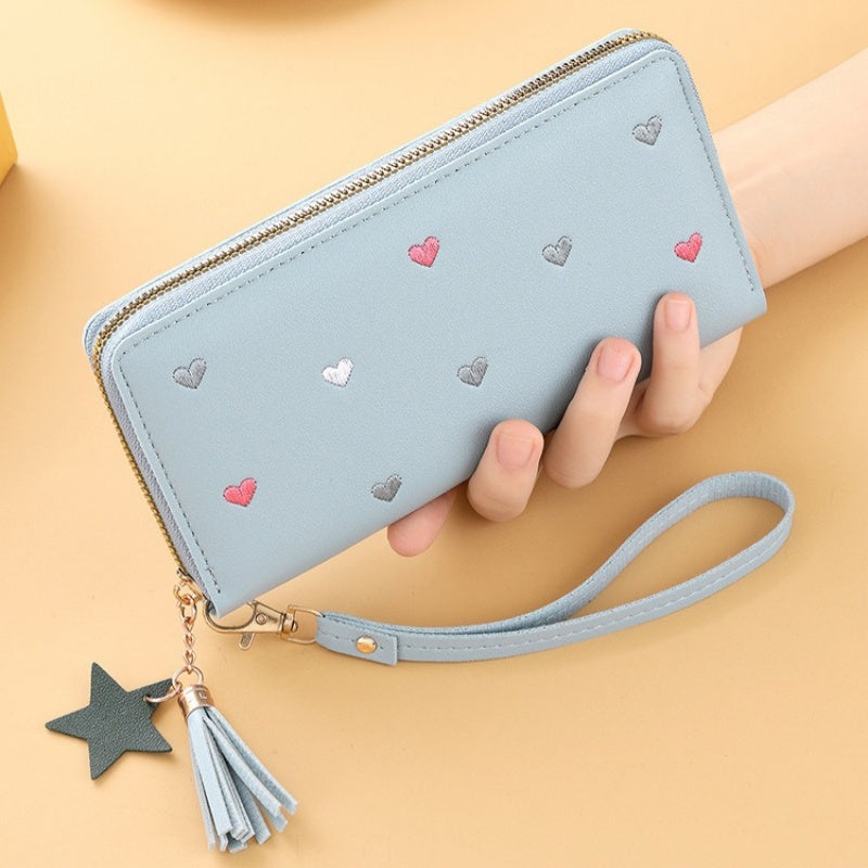 Heart and star embroidered tassel wallet with Korean style, zip-around coin purse. Ideal gift for special occasions. Embroidered clutch in faux leather material.