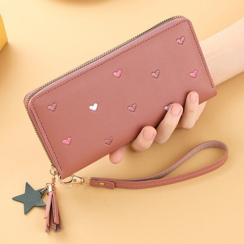 Heart and star embroidered tassel wallet with Korean style, zip-around coin purse. Ideal gift for special occasions. Embroidered clutch in faux leather material.