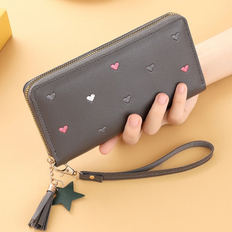 Heart and star embroidered tassel wallet with Korean style, zip-around coin purse. Ideal gift for special occasions. Embroidered clutch in faux leather material.