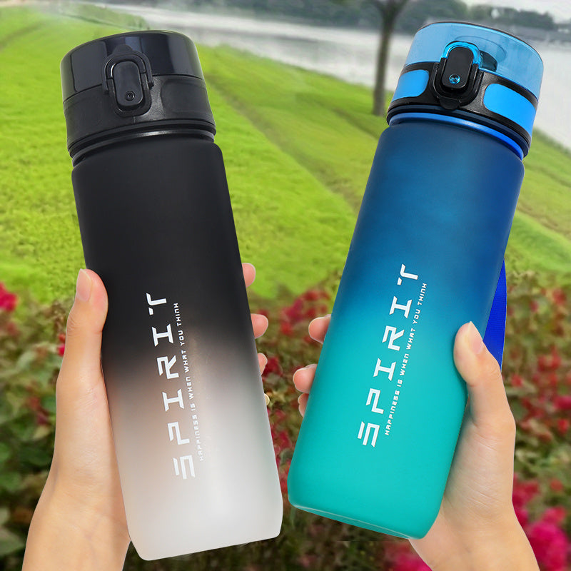 Gradient sports water bottle with strap, leak-proof, large capacity, portable, frosted, BPA-free plastic, flip top lid, ideal for fitness and students.