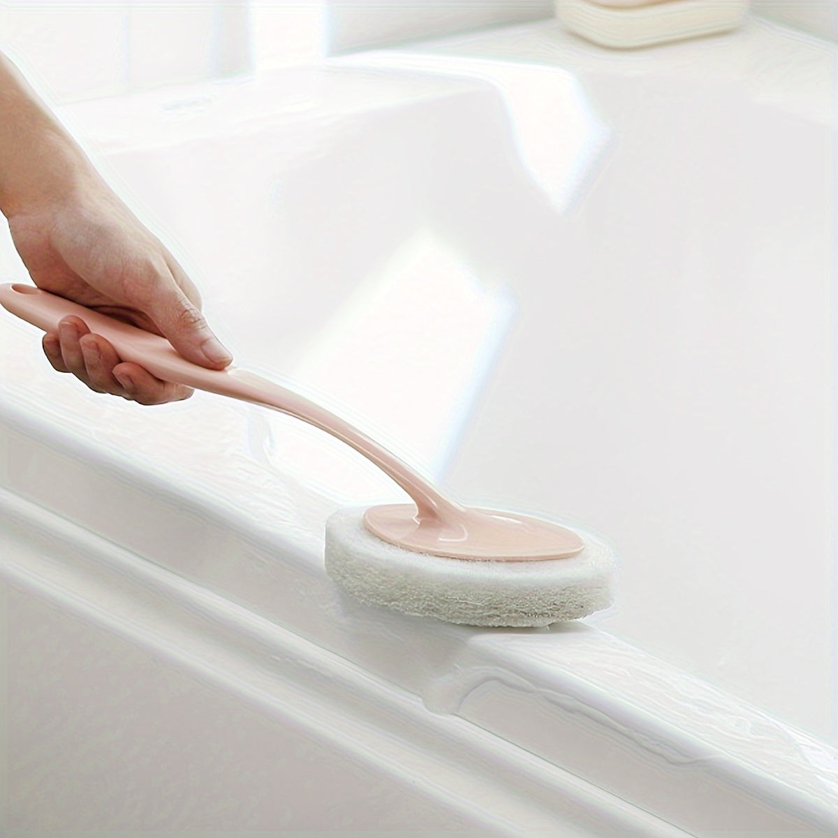 A long-handled sponge brush for cleaning the bathroom walls, bathtub, floor tiles, and sink, as well as a scrub pad for thorough cleaning of the toilet.