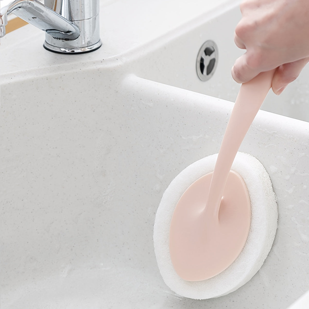 A long-handled sponge brush for cleaning the bathroom walls, bathtub, floor tiles, and sink, as well as a scrub pad for thorough cleaning of the toilet.