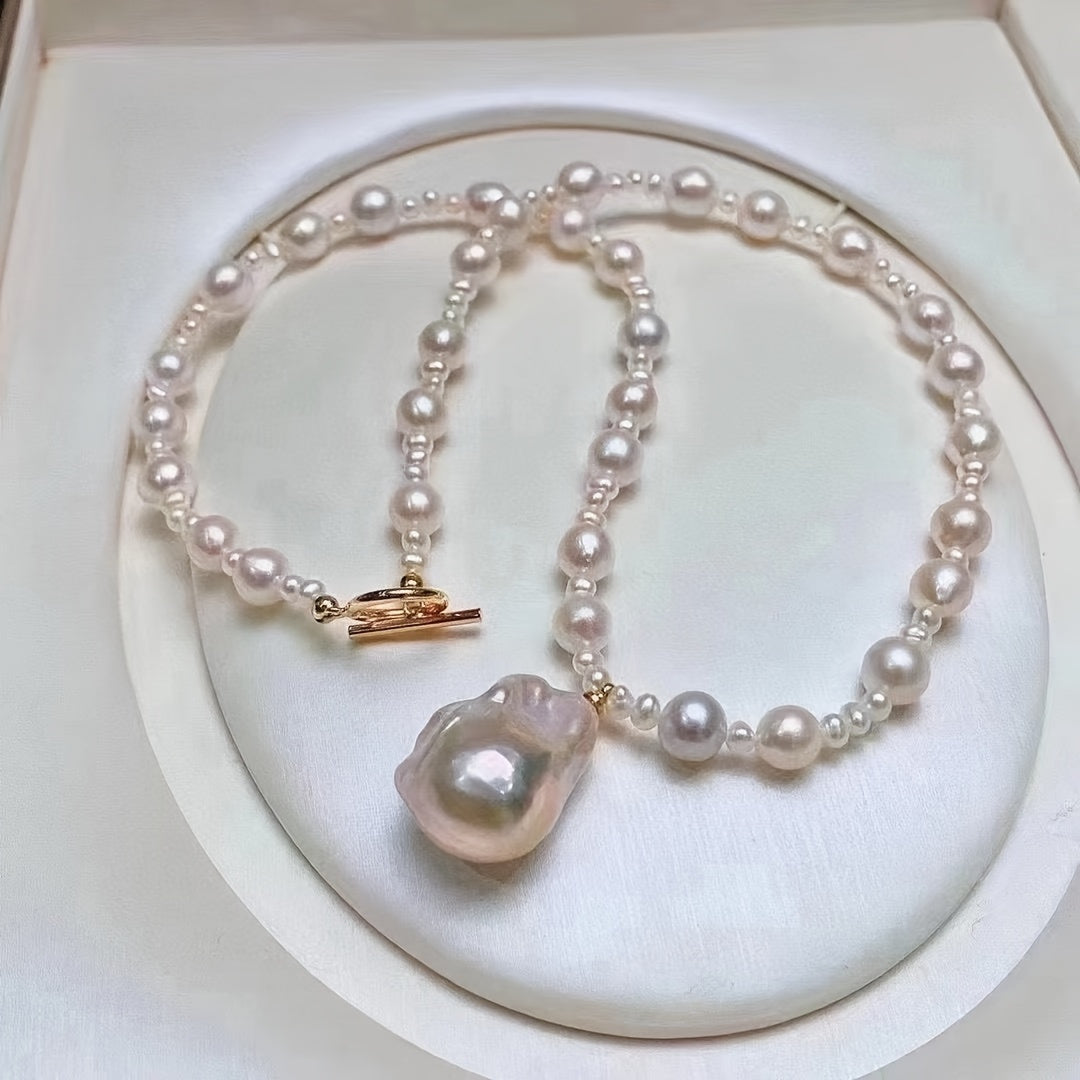 This exquisite freshwater pearl necklace features an OT clasp and a baroque style pendant, suitable for both women and men. It is a classic pearl strand perfect for daily wear or special occasions, including Mardi Gras festivities.