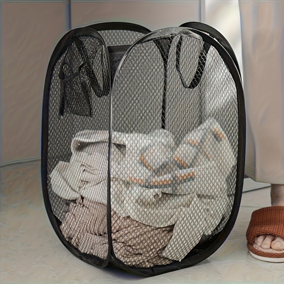 Spacious pop-up laundry basket with handles for convenient storage and organization in multiple rooms, featuring a modern mesh design and utility hooks.