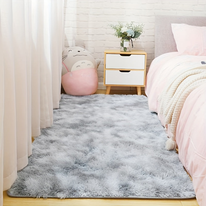 Soft and fluffy light gray rug with non-slip bottom, perfect for bedroom or living room.