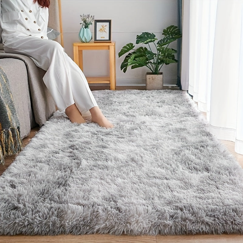 Soft and fluffy light gray rug with non-slip bottom, perfect for bedroom or living room.