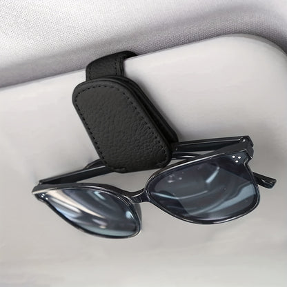 Stylish magnetic PU leather glasses holder for car visor with black textured grip. Compact design for easy access and secure storage.